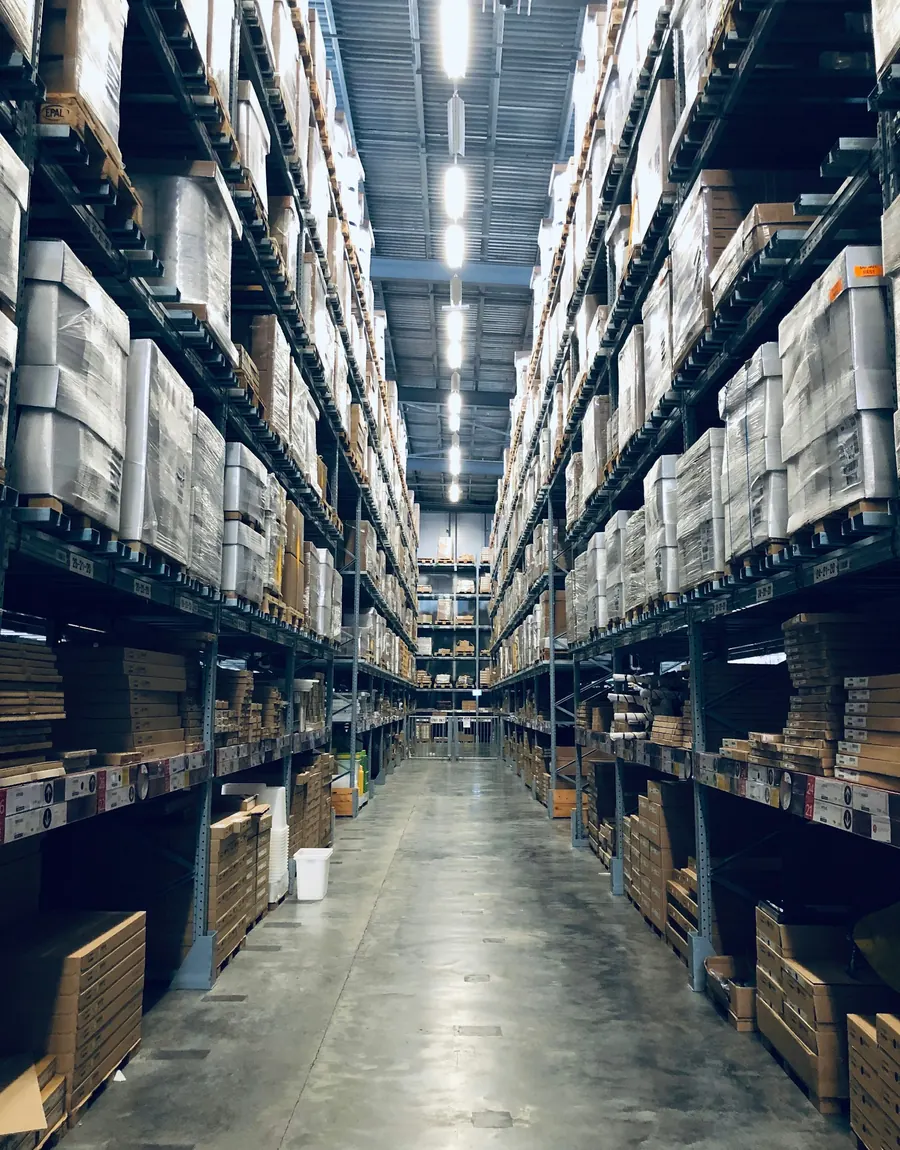 Long aisle of high warehouse racking loaded with stock