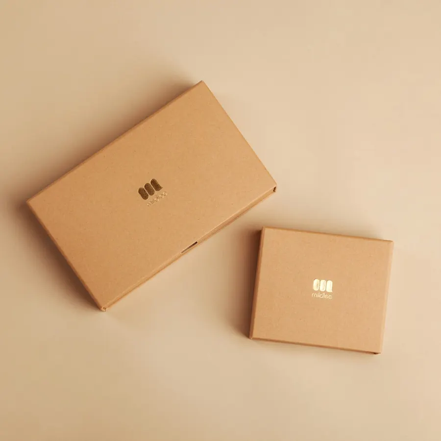 Two plain kraft cartons on a warm background