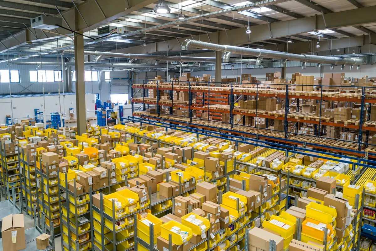 Wide view of a distribution warehouse with loaded pallet racking