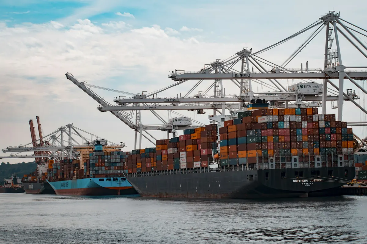Container vessel alongside quay cranes during loading